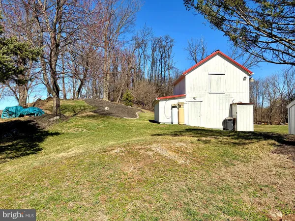 a view of a yard with a house and tree