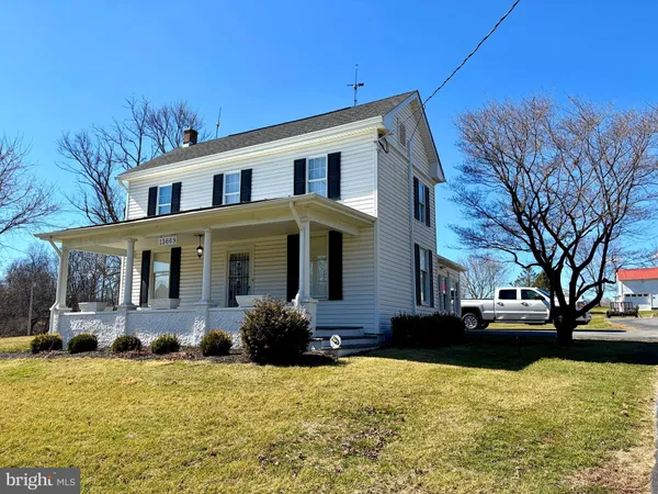 a front view of house with yard and trees around