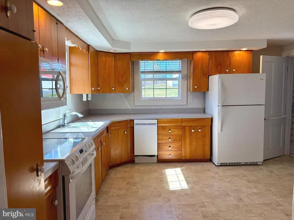 a kitchen with a refrigerator and a stove