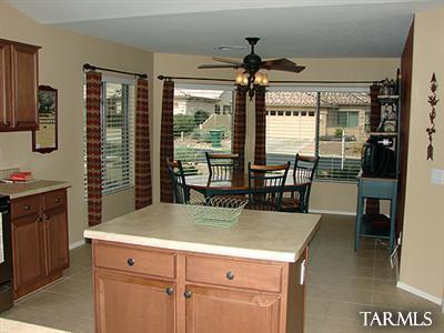 62195 East Northwood Road Tucson, AZ 85739 - Photo 14 of 25 a kitchen with a stove a sink and a refrigerator