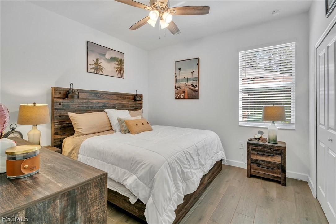17388 Walnut Run Drive Alva, FL 33920 - Photo 13 of 24 a bedroom with bed and a chandelier