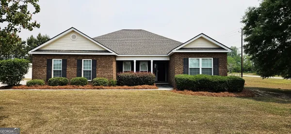 a front view of a house with a yard