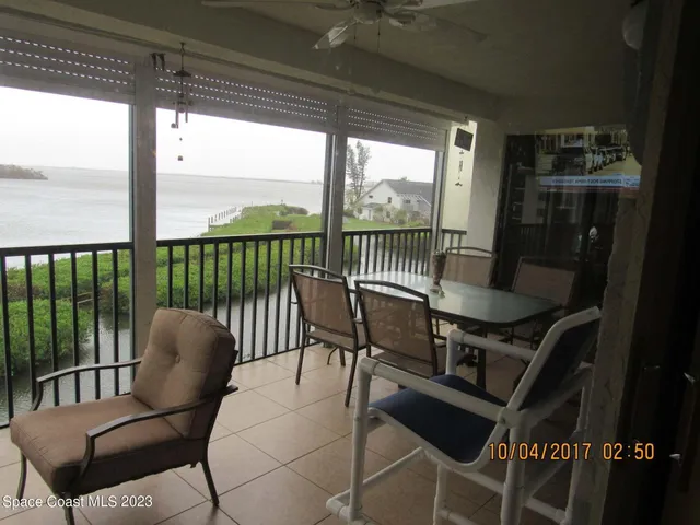 a balcony view with a seating space