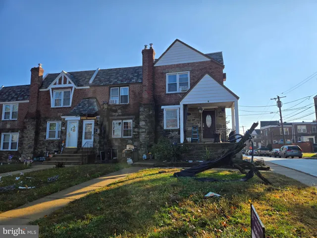 a front view of a house with a yard table and chairs