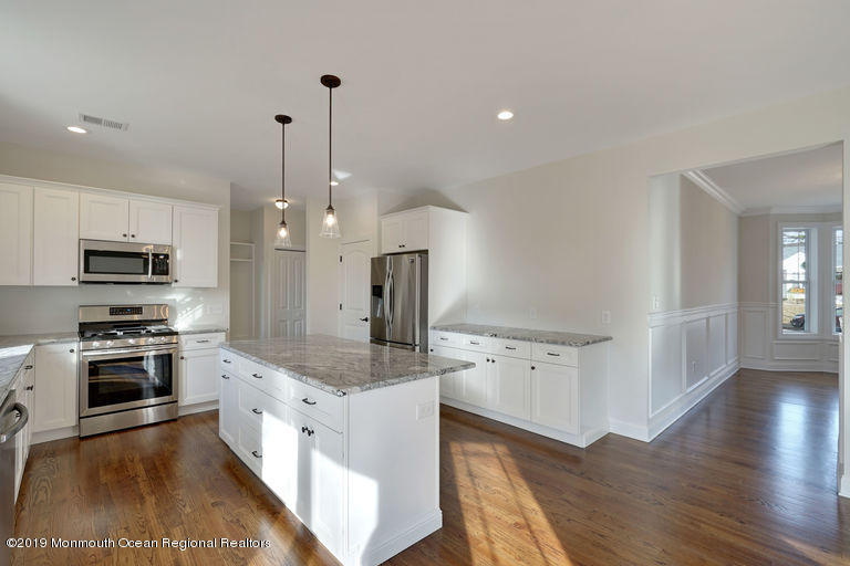 109 Leeward Road Manahawkin, NJ 08050 - Photo 5 of 71 a large kitchen with granite countertop a large counter top space appliances and cabinets
