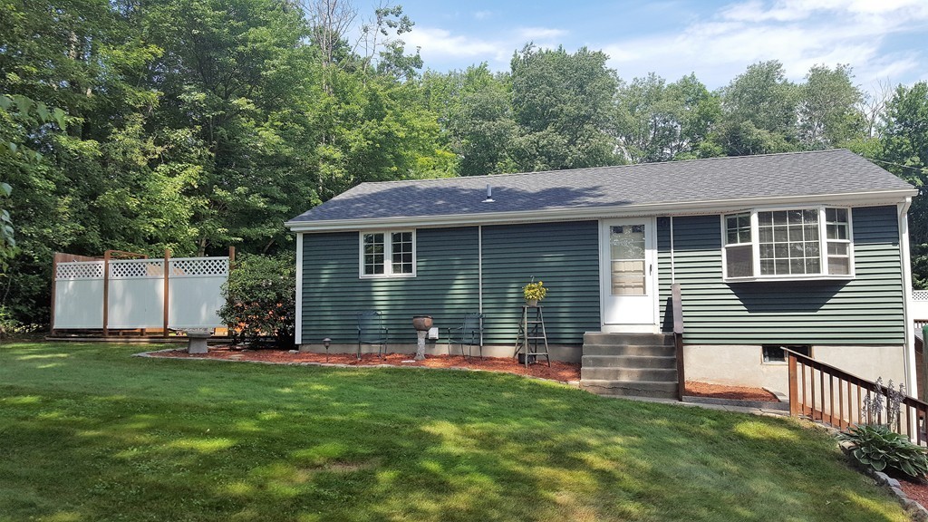 a front view of house with yard and green space