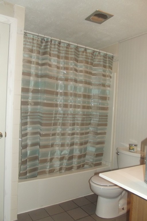 186 Brookfield Road Charlton, MA 01507 - Photo 27 of 28 a bathroom with a shower curtain and a toilet