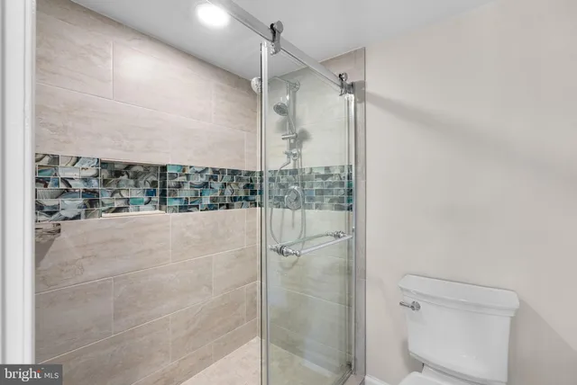 a bathroom with a glass shower door