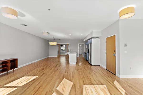 a view of a room with wooden floor