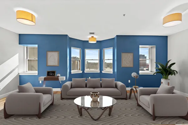 a living room with furniture and a potted plant