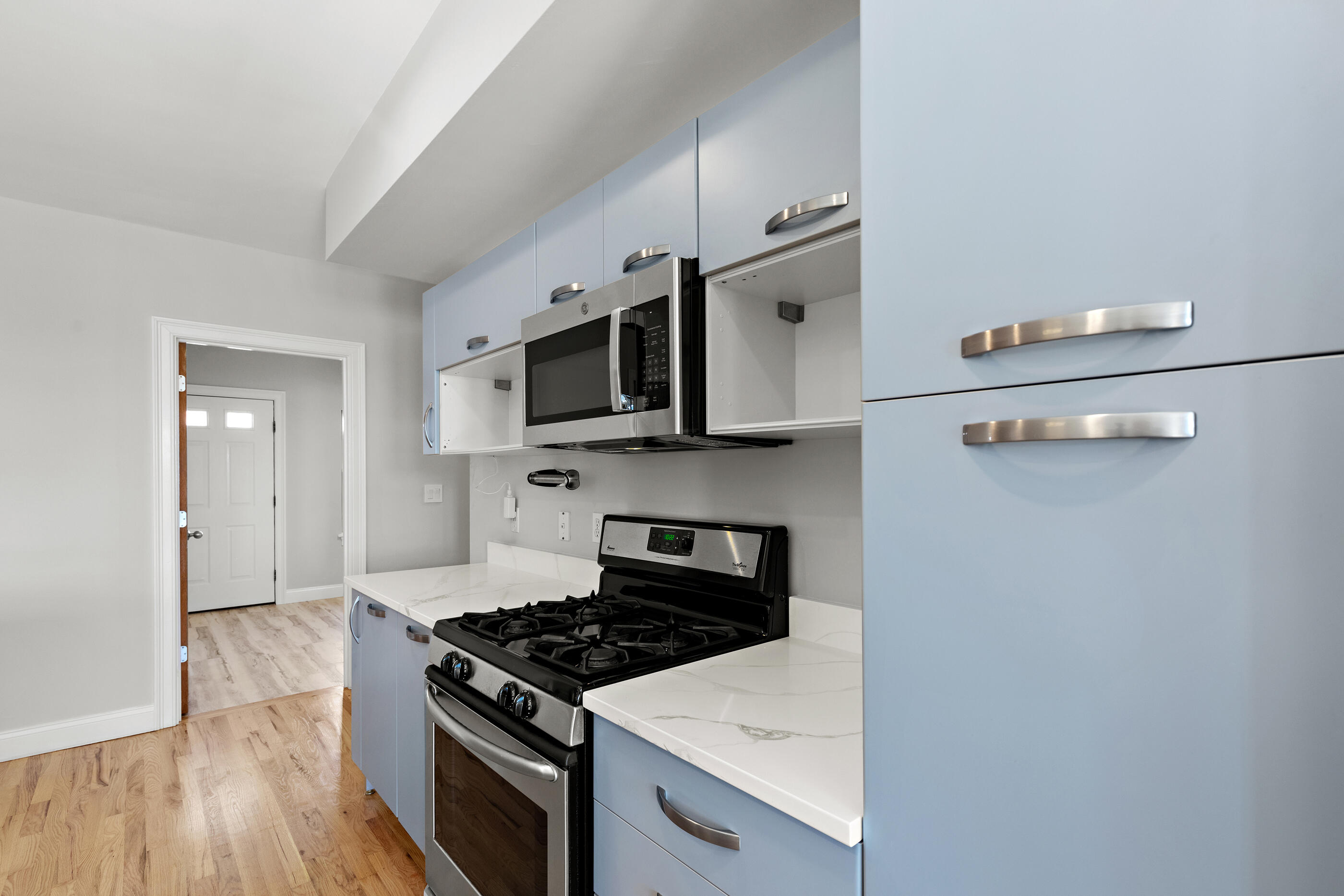 877 Harrison Avenue, Unit 7 Boston, MA 02118 - Photo 17 of 34 a kitchen with a stove and a microwave
