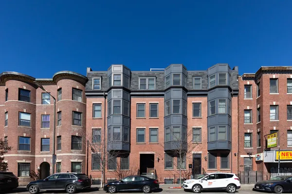 a front view of a building with parking space