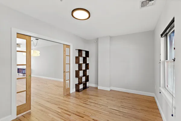 wooden floor in an empty room with a window