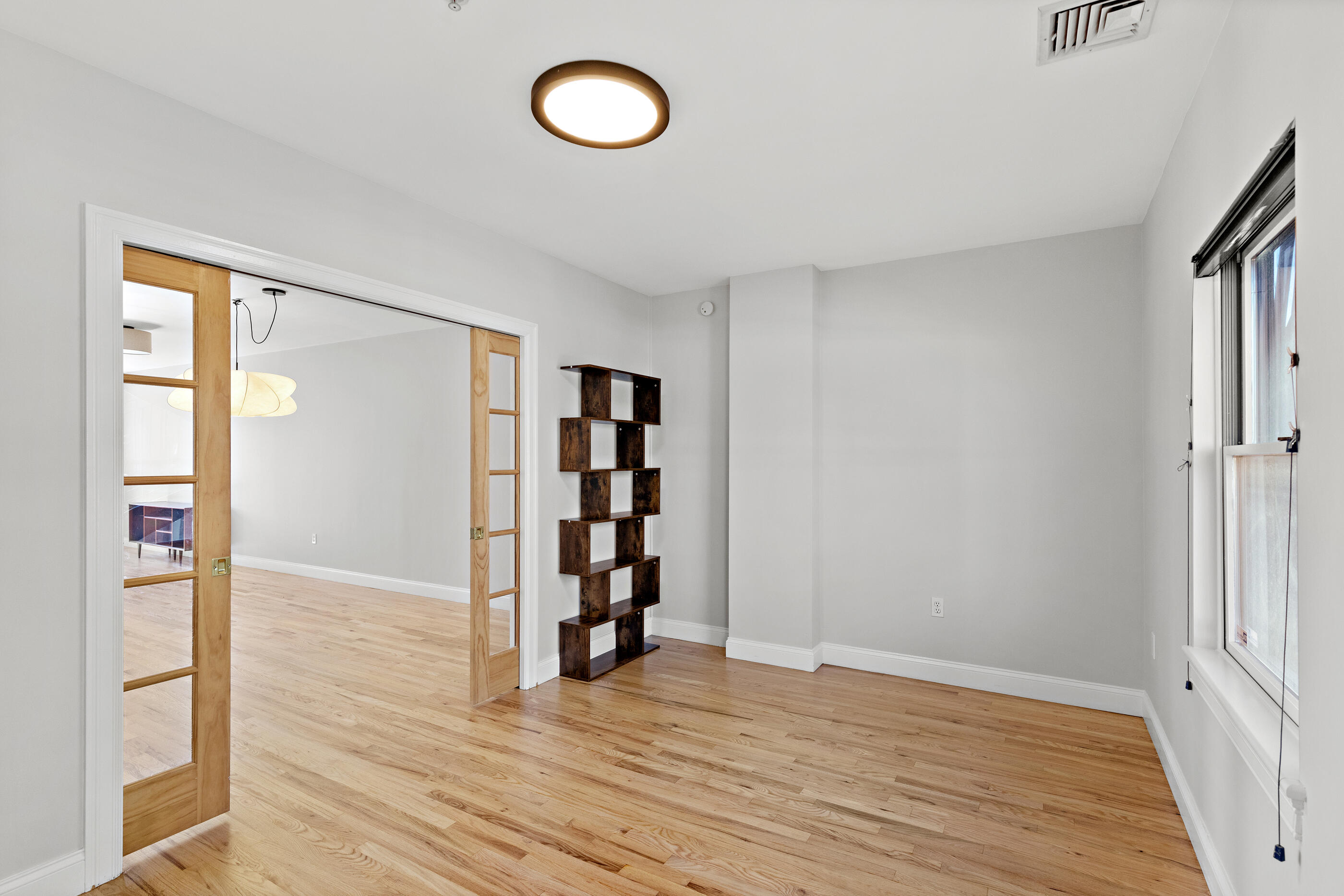 877 Harrison Avenue, Unit 7 Boston, MA 02118 - Photo 22 of 34 wooden floor in an empty room with a window