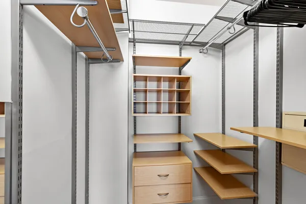 a view of walk in closet with empty racks