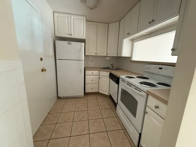a view of empty room with wooden floor and cabinet