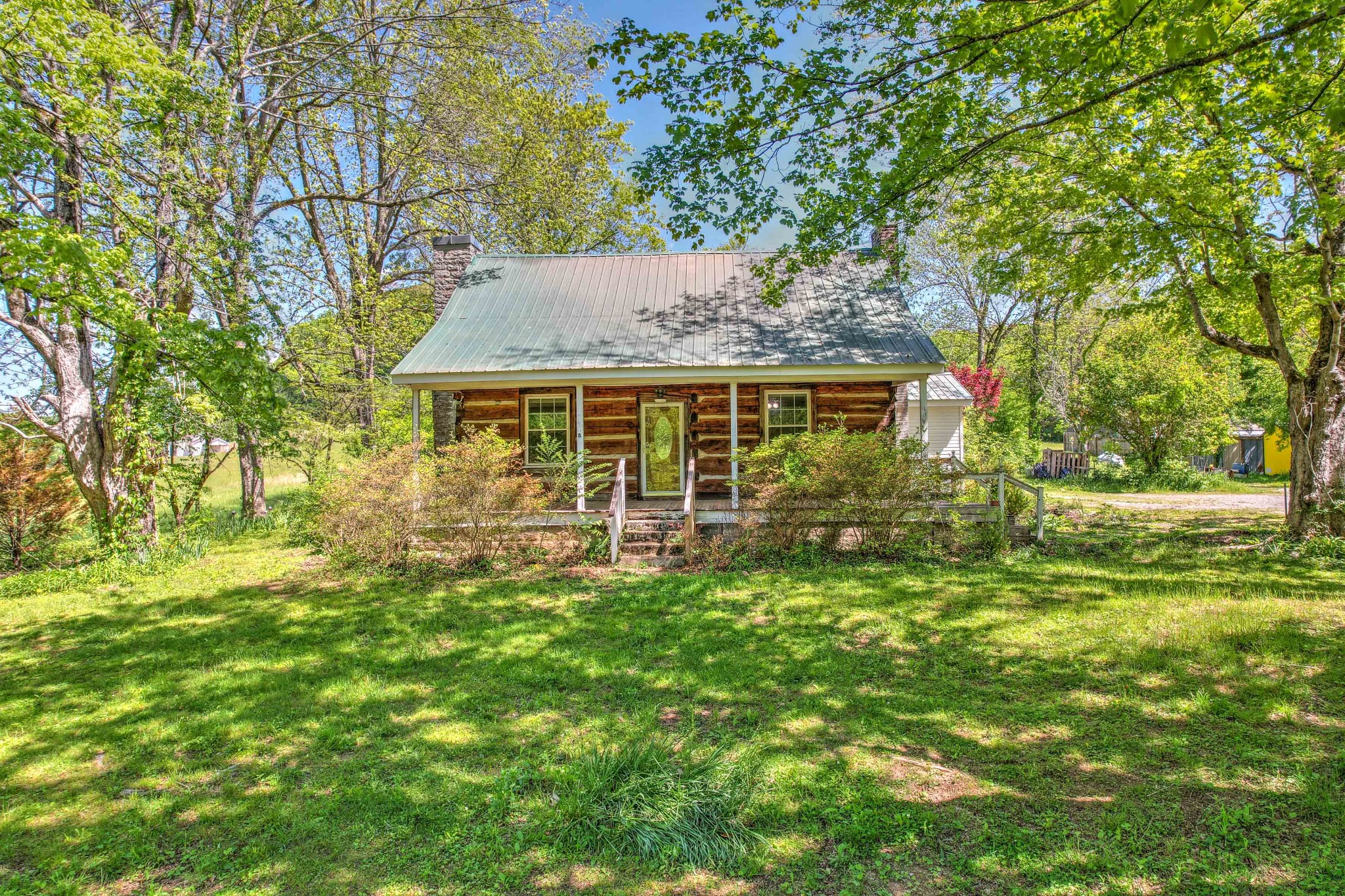 a view of house with a yard