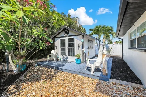 a view of a house with backyard porch and sitting area