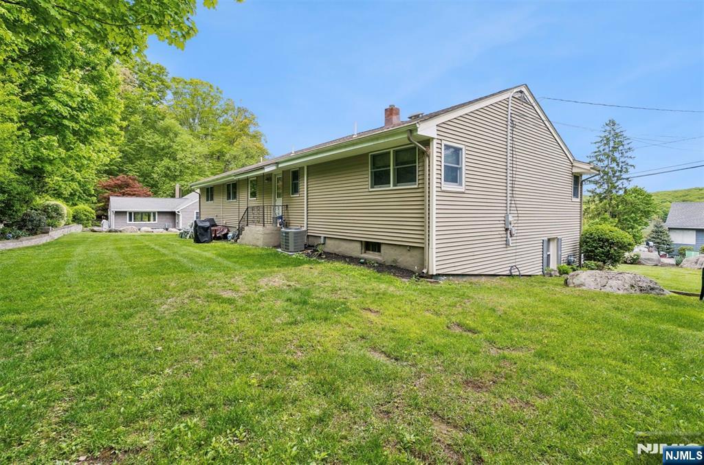 6 Waters Edge Butler, NJ 07405 - Photo 19 of 28 a view of a house with a yard