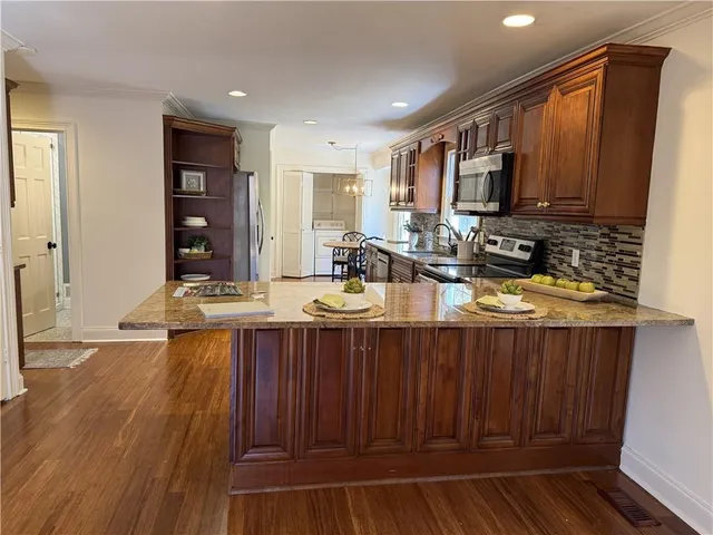 a kitchen with a sink appliances and cabinets