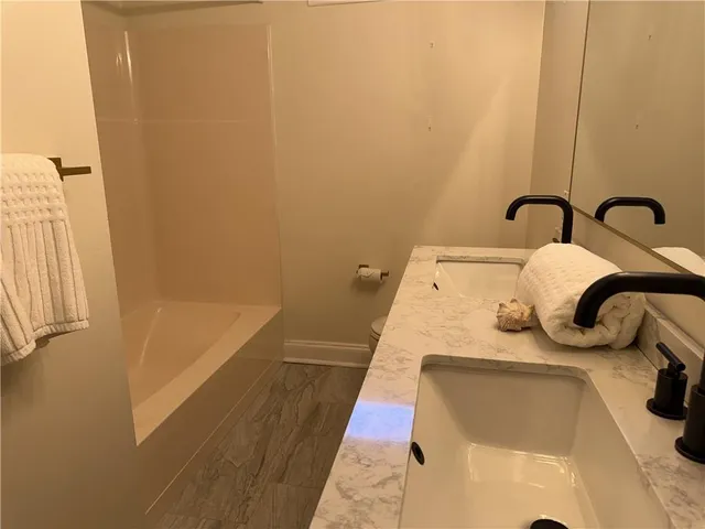 a bedroom with a bed and a tub