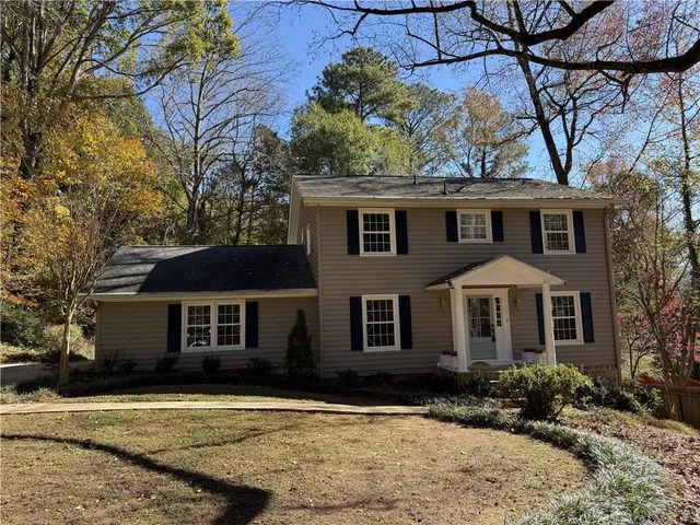 a front view of a house with a yard