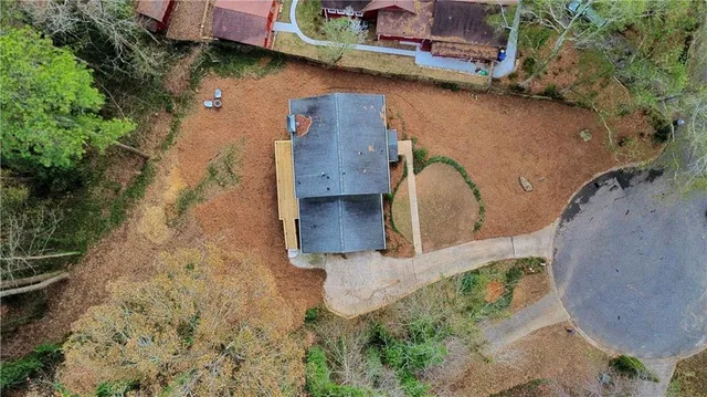 an aerial view of residential houses with yard and trees