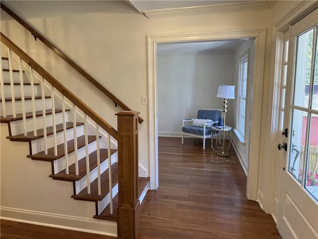 a view of entryway and hall with wooden floor