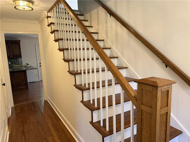 a view of entryway with wooden floor and stairs