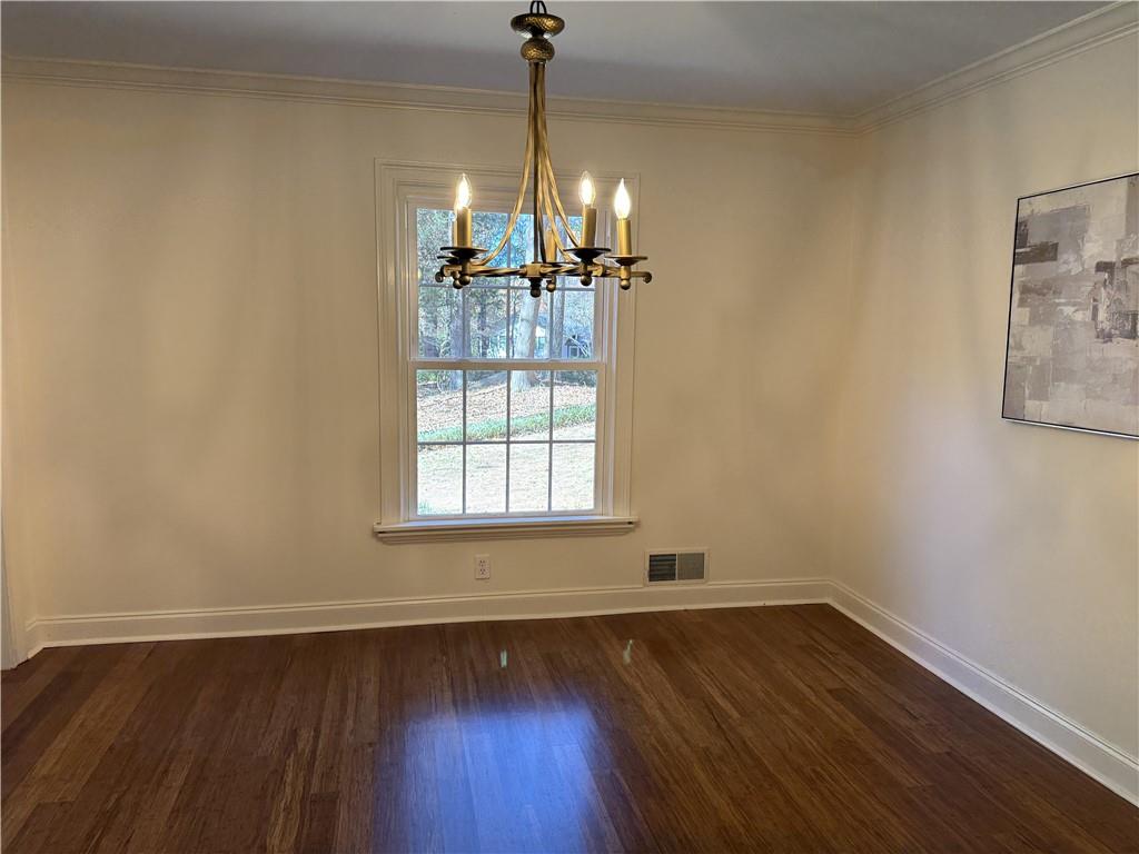 1610 Old Mill Crossing Northeast Marietta, GA 30062 - Photo 10 of 55 a view of a room with wooden floor chandelier and a window