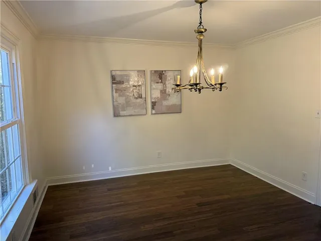 a view of a room with wooden floor and ceiling fan