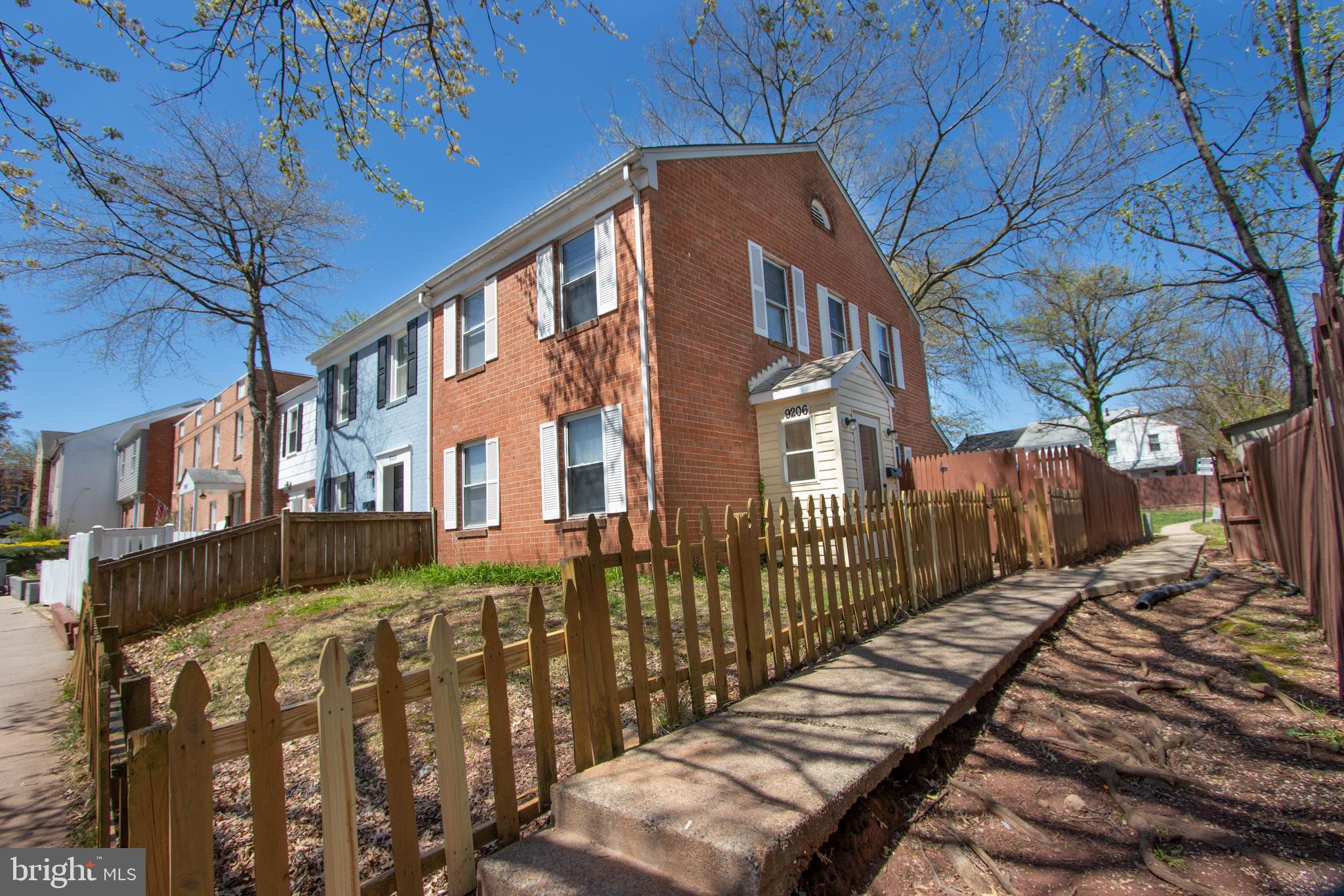 9206 Hood Road Manassas, VA 20110 - Photo 1 of 25 a view of a blue house with wooden fence