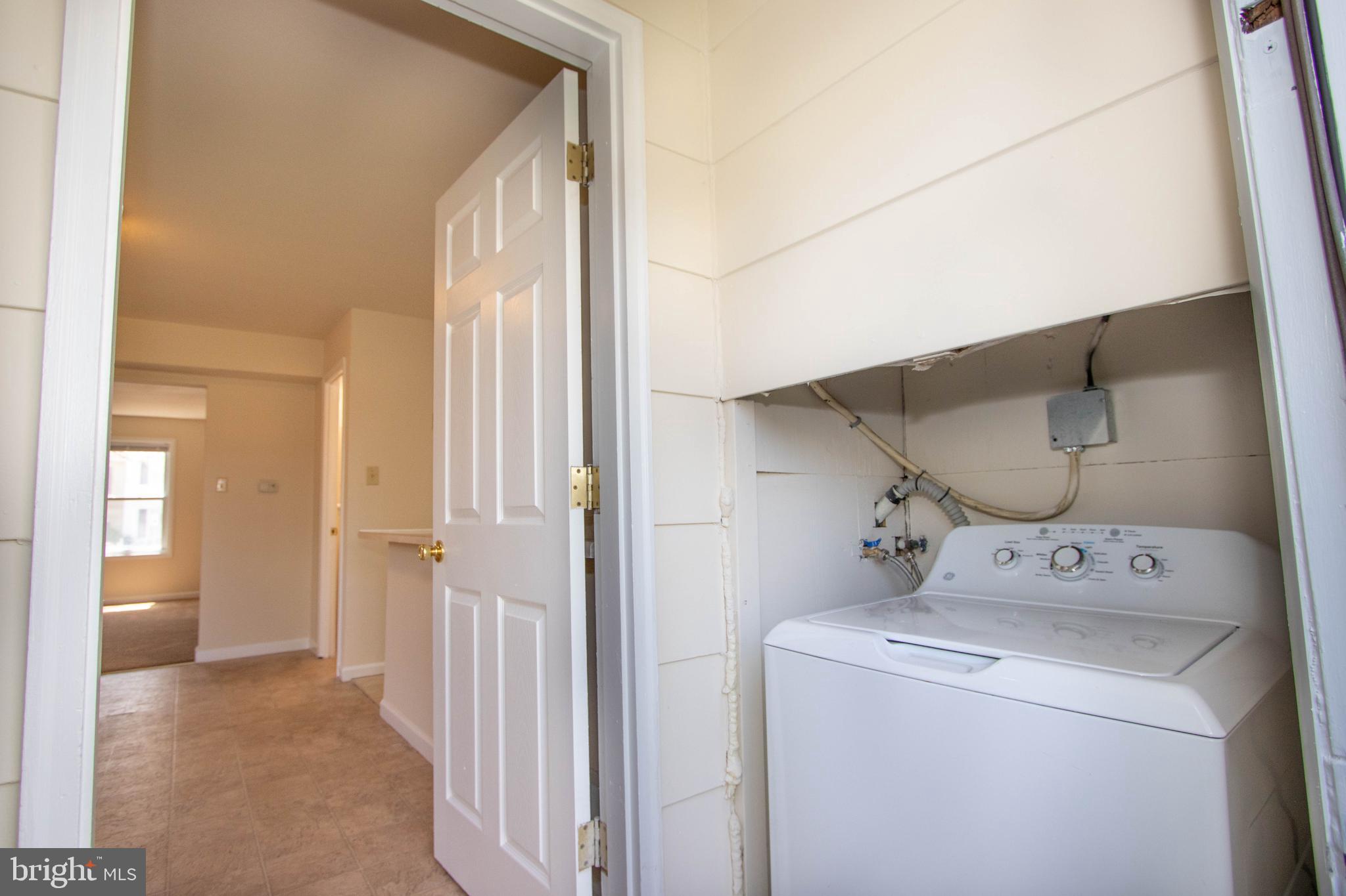 9206 Hood Road Manassas, VA 20110 - Photo 22 of 25 a view of washer and dryer with bathroom in the background