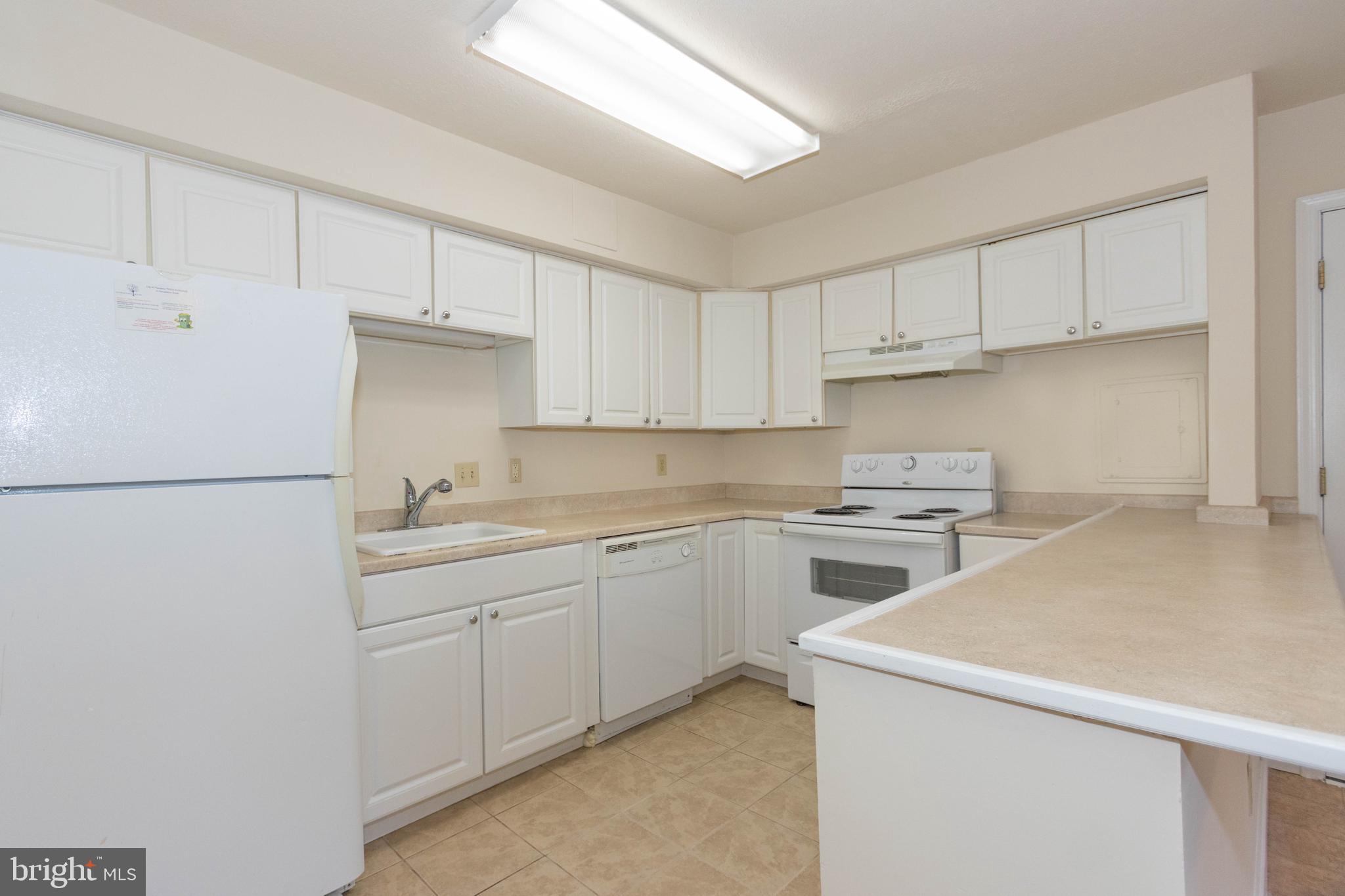 9206 Hood Road Manassas, VA 20110 - Photo 5 of 25 a kitchen with a sink a stove a refrigerator and white cabinets