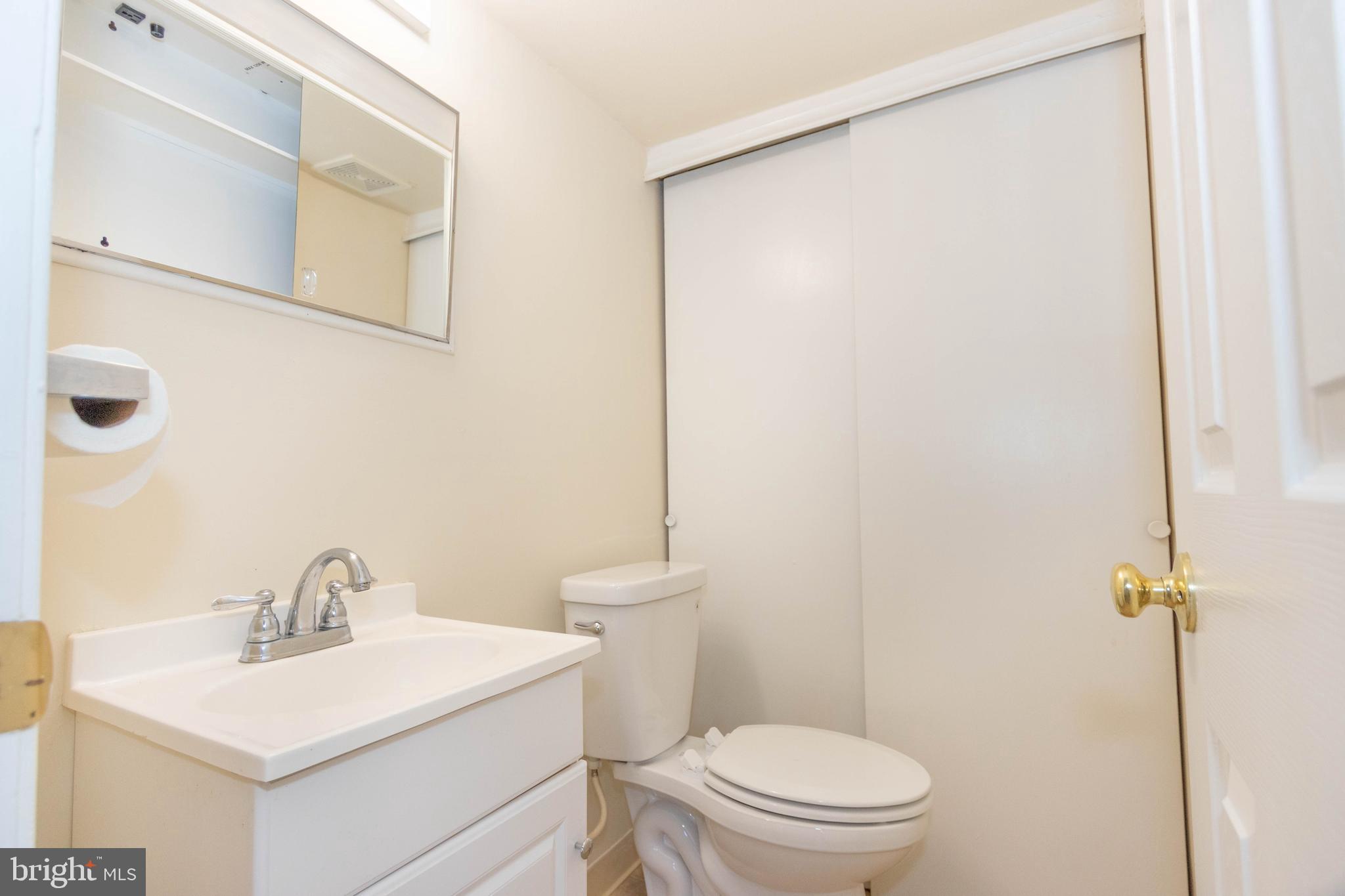 9206 Hood Road Manassas, VA 20110 - Photo 8 of 25 a bathroom with a sink a toilet and a mirror