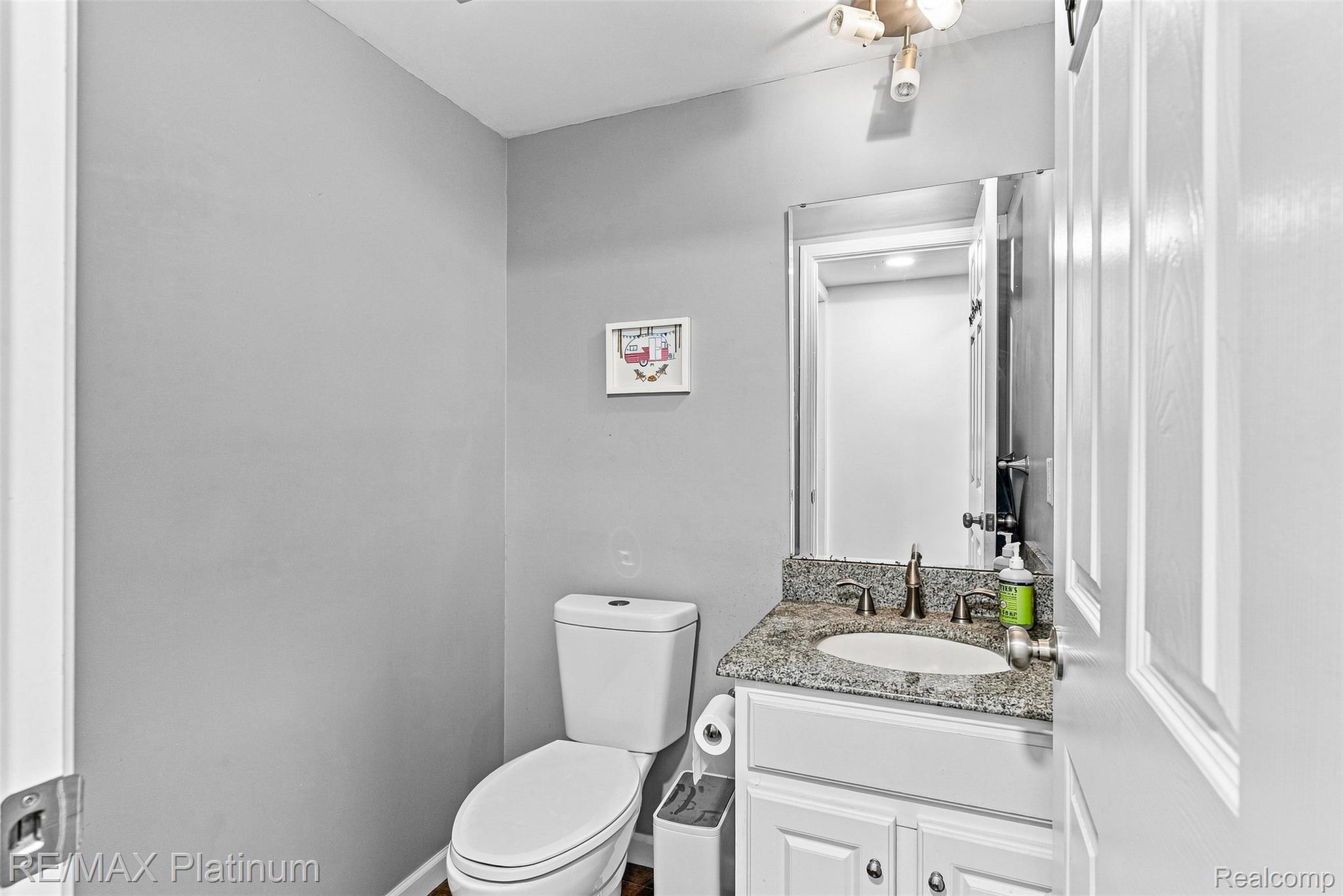 815 Oak Ridge Court Brighton, MI 48116 - Photo 31 of 37 Vanity with granite countertop, integrated sink, and bronze-finish faucet