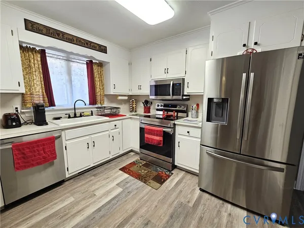 a kitchen with stainless steel appliances a refrigerator sink and microwave