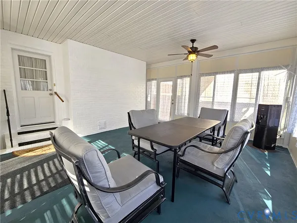 a dining room with furniture and window