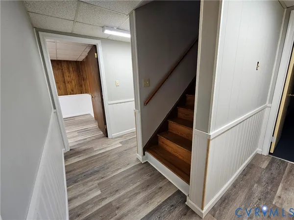 a view of entryway and hall with wooden floor