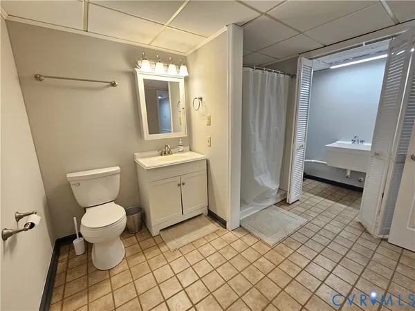 a bathroom with a toilet sink and a mirror