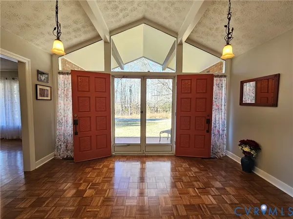 a view of a room with a front door and windows
