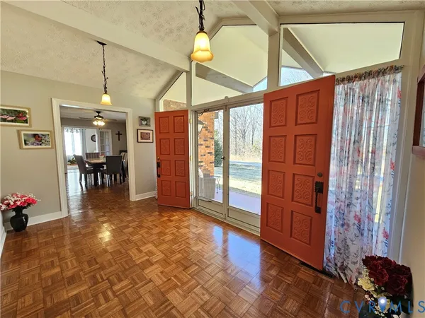 a view of a livingroom with furniture and hardwood floor
