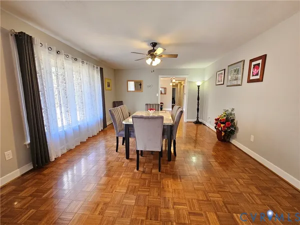 a view of a dining room with furniture and a chandelier