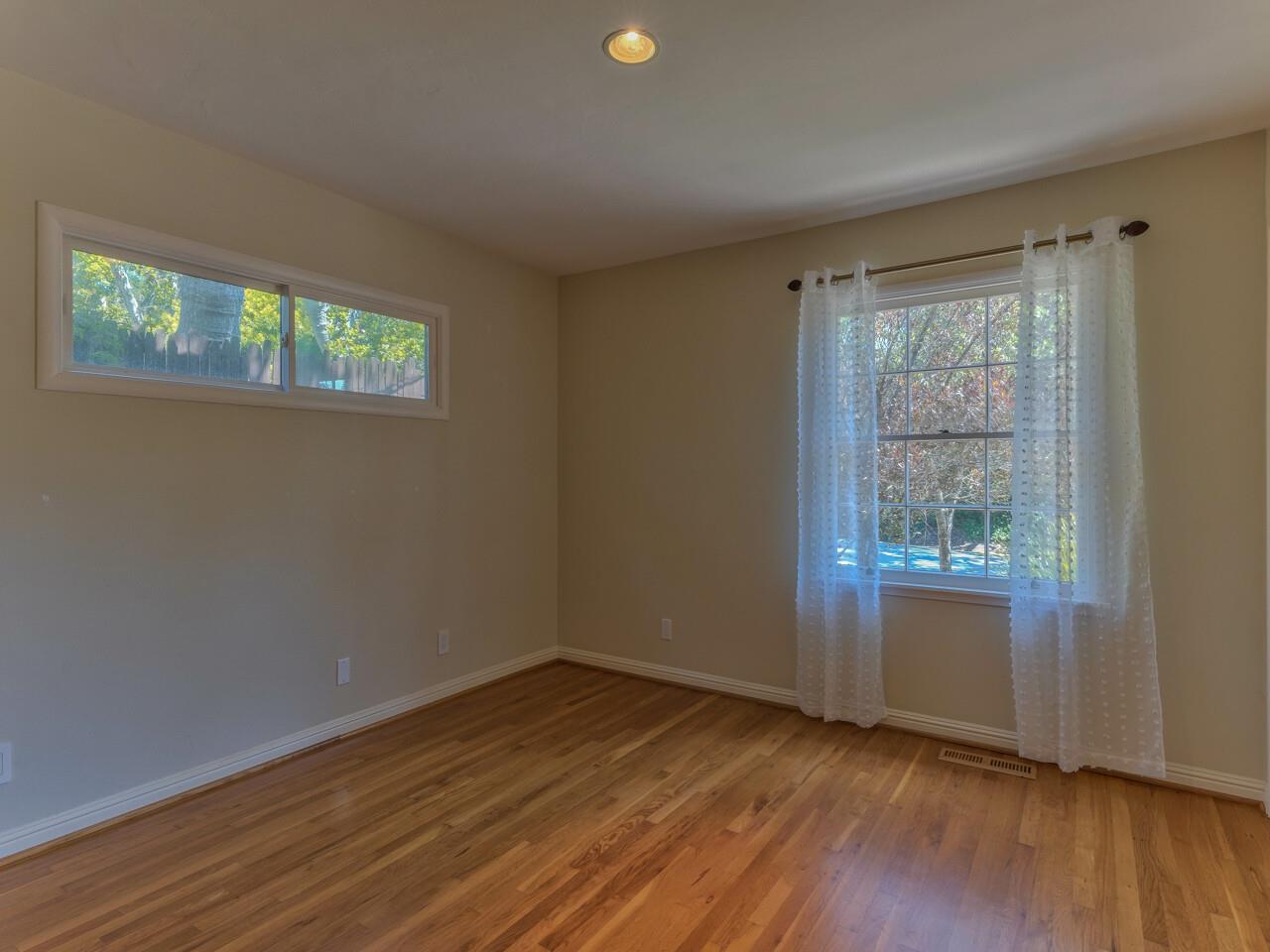 2 Perry Newberry Way Carmel, CA 93923 - Photo 22 of 30 a view of an empty room with wooden floor and a window