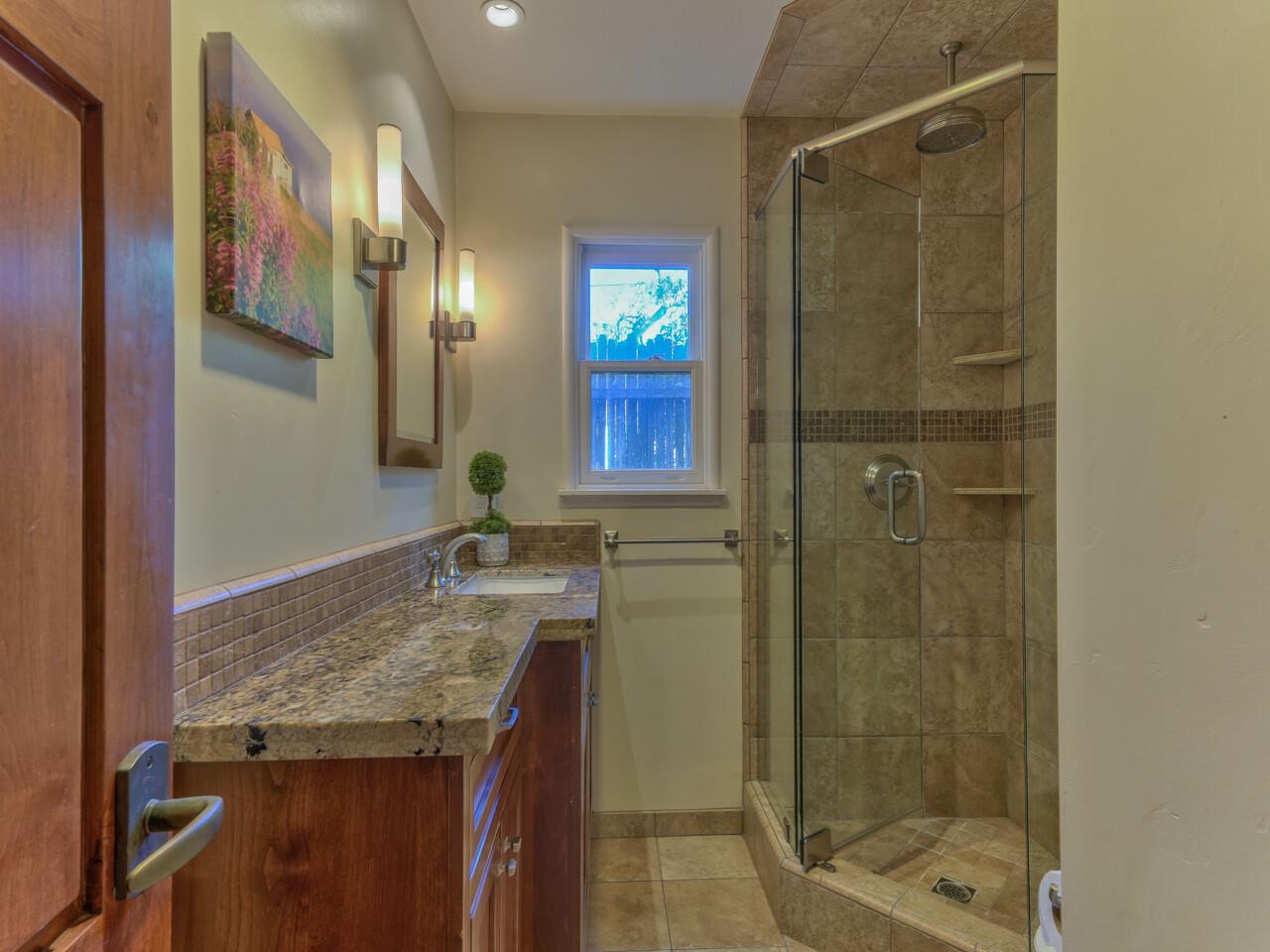 2 Perry Newberry Way Carmel, CA 93923 - Photo 24 of 30 a bathroom with a granite countertop sink a mirror and shower
