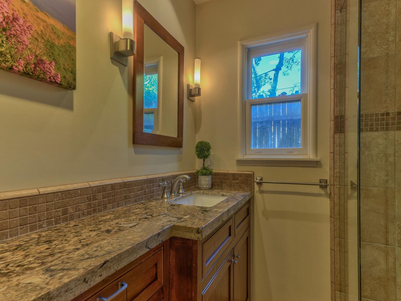 2 Perry Newberry Way Carmel, CA 93923 - Photo 25 of 30 a bathroom with a granite countertop sink and a mirror