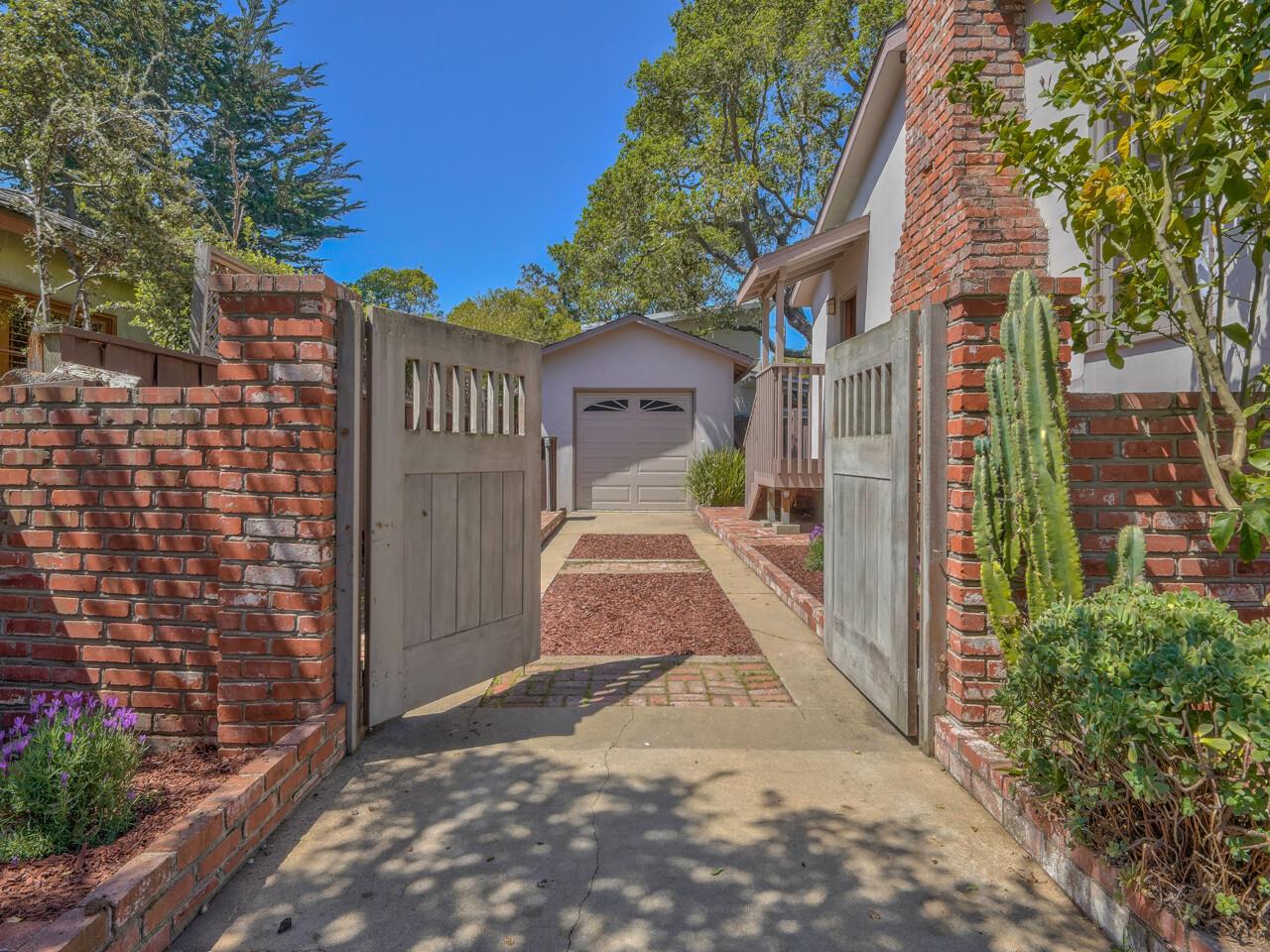 2 Perry Newberry Way Carmel, CA 93923 - Photo 29 of 30 a view of a brick house with large windows plants and large tree