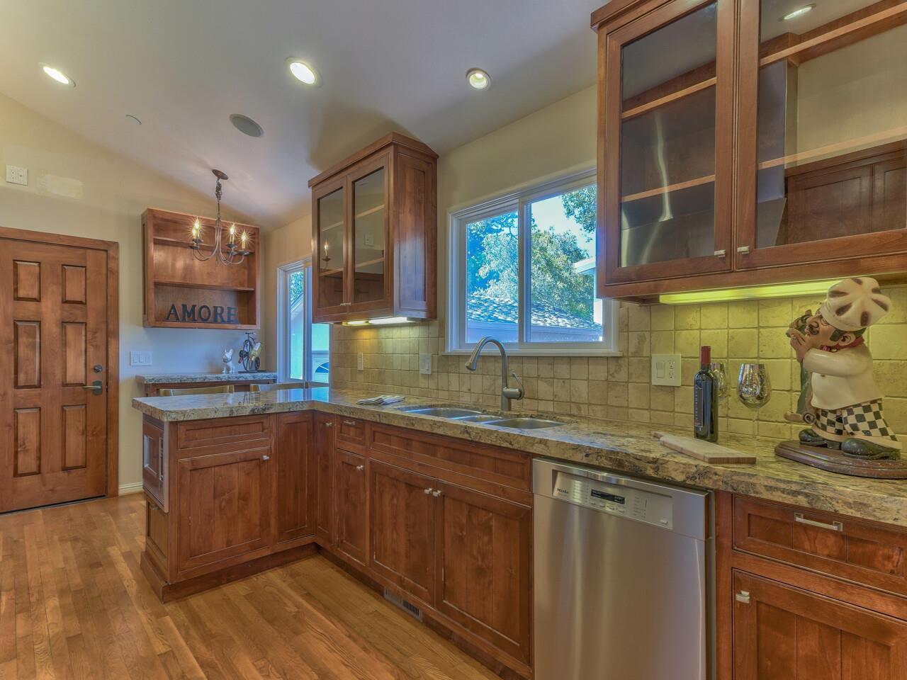 2 Perry Newberry Way Carmel, CA 93923 - Photo 4 of 30 a kitchen with stainless steel appliances granite countertop a sink a stove and a wooden cabinets