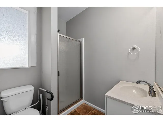 a bathroom with a sink toilet and mirror