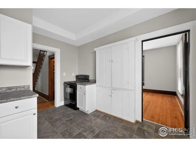 a kitchen with refrigerator and cabinets